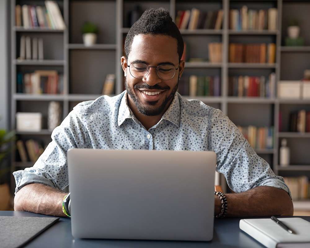 Black man at a laptop having an online therapy session in New Jersey