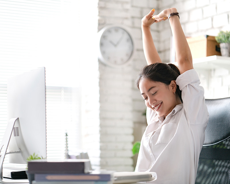 Asian woman at a desk in front of a computer for individual therapy