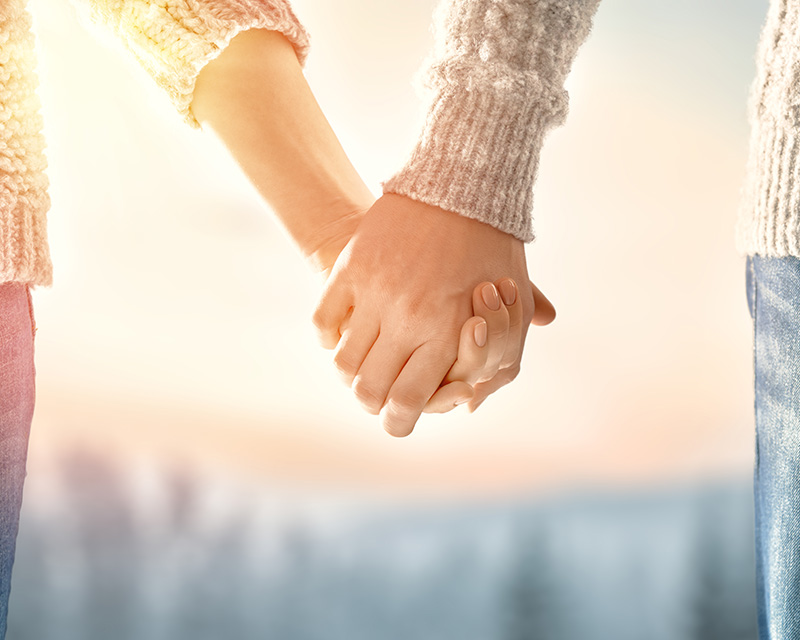 Couple holding hands after marriage coaching